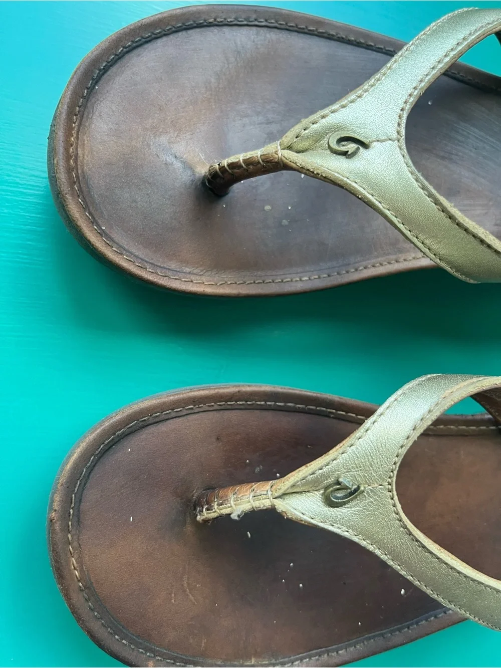 OluKai Wedge Flip Flop Sandals in Metallic Gold